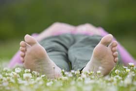 Woman enjoying nature on a summer day in a field of daisies. © Pete Cairns / naturepl.com / WWF