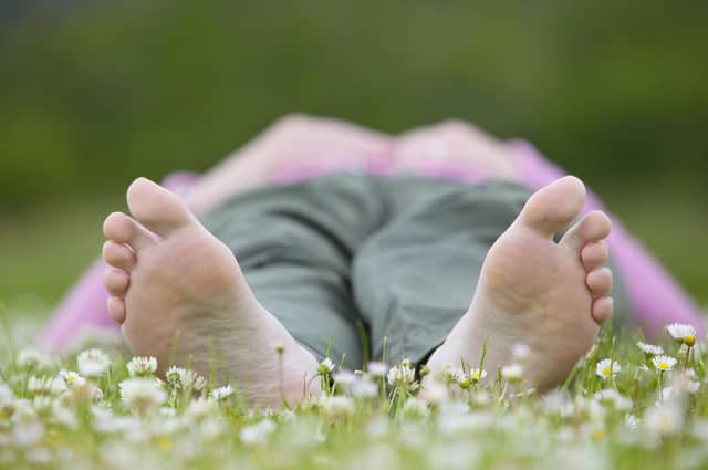 Woman enjoying nature on a summer day in a field of daisies. © Pete Cairns / naturepl.com / WWF