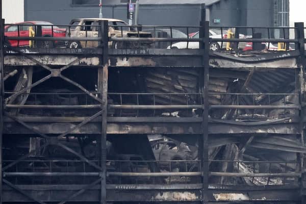 Burned out cars are pictured in a charred section of car park, following a fire at London's Luton Airport on October 11, 2023.(Photo by HENRY NICHOLLS/AFP via Getty Images)