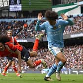 Town midfielder Tahith Chong is fouled by Manchester City defender Rico Lewis - pic: DARREN STAPLES/AFP via Getty Images