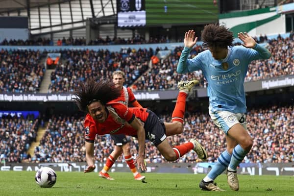Town midfielder Tahith Chong is fouled by Manchester City defender Rico Lewis - pic: DARREN STAPLES/AFP via Getty Images