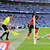 Elijah Adebayo looks to get past his man at Wembley
