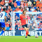 Tom Lockyer makes a pass during Saturday's Premier League opener with Brighton - pic: Liam Smith