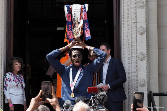 Striker Elijah Adebayo holding the trophy