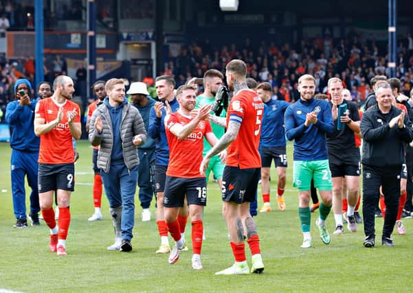 Luton's players celebrate reaching the Championship play-offs by beating Reading on Saturday