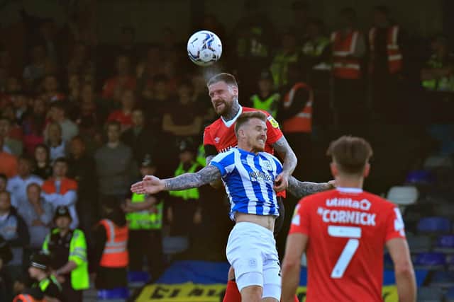 Sonny Bradley gets up to head clear against Huddersfield