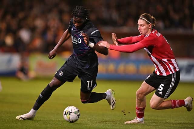 Elijah Adebayo is challenged by Exeter's Alex Hartridge - pic: Harry Trump/Getty Images