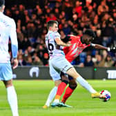 Town striker Elijah Adebayo battles for possession against Norwich on Boxing Day
