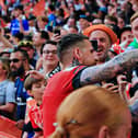 Sonny Bradley feeds champagne to a Luton fan at Wembley