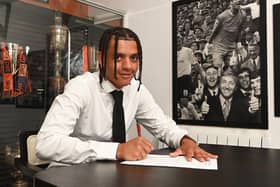 Jayden Luker putting pen to paper with Luton in the summer