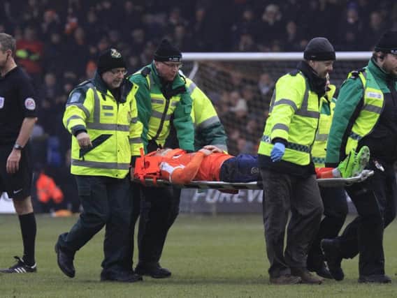 Jordan Cook is stretchered off against Crawley this afternoon.