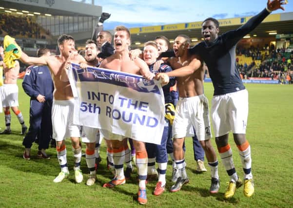 Luton Town players celebrate their famous FA Cup win at Norwich in January 2013