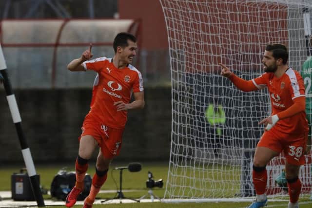 Town defender Dan Potts celebrates his sixth of the season