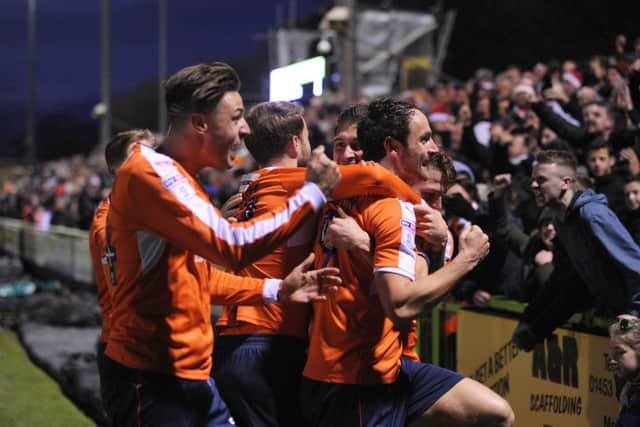 Danny Hylton celebrates with the travelling Luton fans