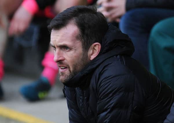 Hatters boss Nathan Jones watches on at Forest Green