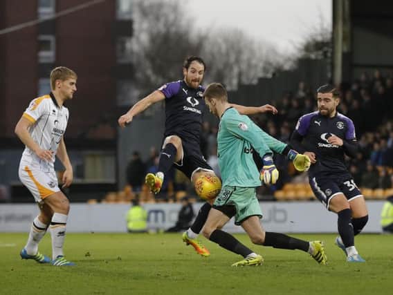 Danny Hylton tries to charge down Vale keeper Ryan Boot this afternoon