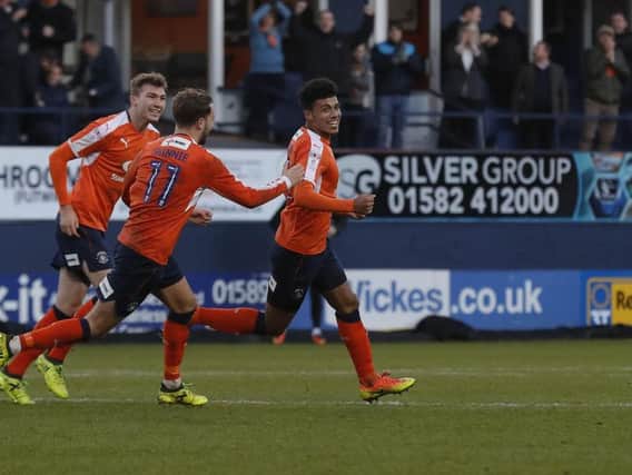 James Justin celebrates drawing Luton level against Lincoln City
