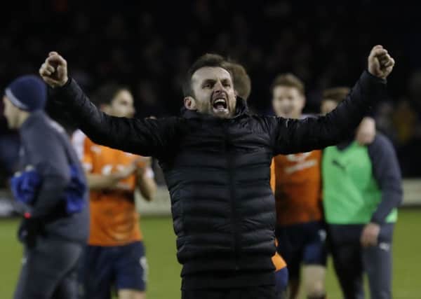 Hatters boss Nathan Jones roars in celebration after beating Lincoln 4-2