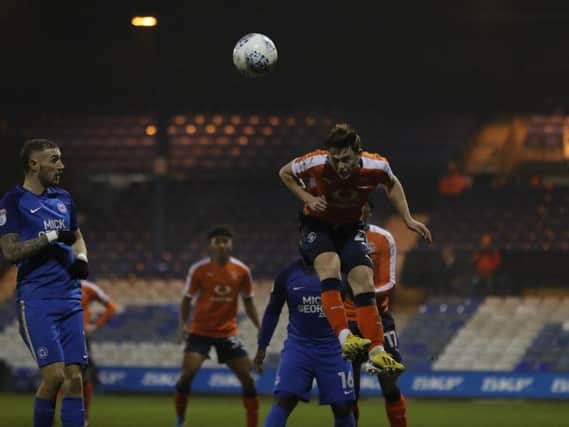 Jack Senior heads the ball clear against Peterborough this evening