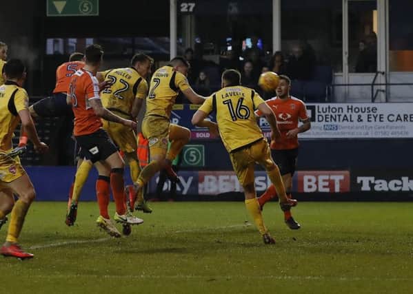 Johnny Mullins rises highest to head home against Morecambe