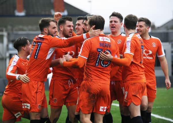 Luton celebrate James Collins' winning goal at Grimsby