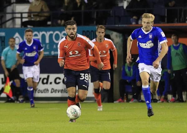 Flynn Downes chases Elliot Lee during Ipswich's 2-0 Carabao Cup win in August