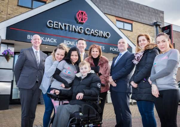 Cameron Connelly was presented with the powered wheelchair by representatives from Genting Casino and CHIPS charity