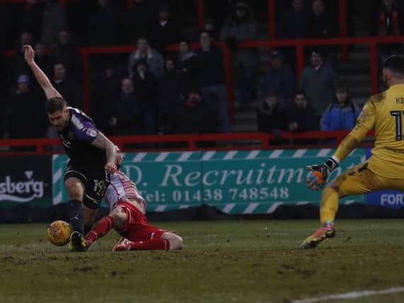 James Collins is brought down by Stevenage defender Ronnie Henry
