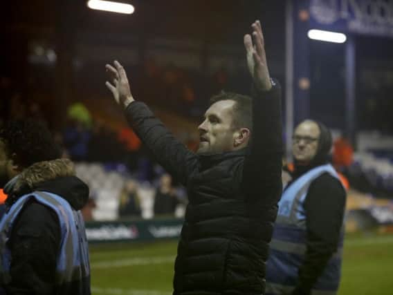 Hatters boss Nathan Jones celebrates with the fans after beating Crawley 4-1