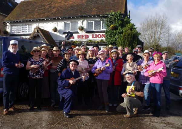 The Last of the Summer Ukuleles. Jacky is pictured in the middle wearing the pink trilby and starry top.
