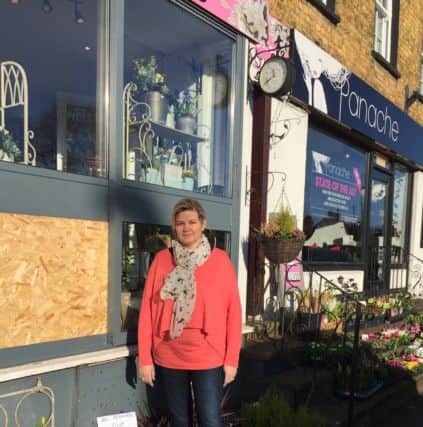 Mary-Anne with the boarded up shop window.