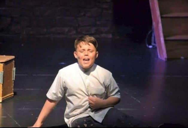 Shaun sings his heart out as Oliver at the Grove Theatre (age 10).