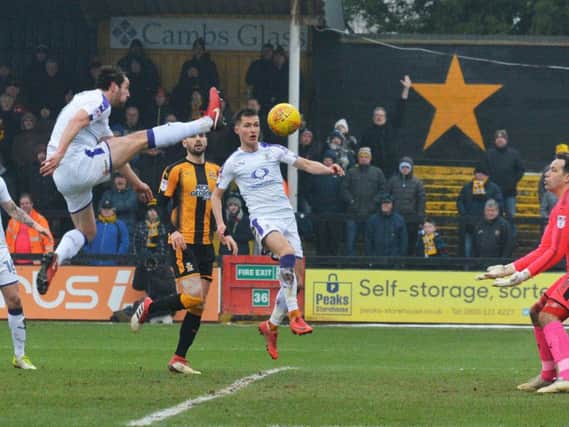 Danny Hylton stretches against Cambridge this afternoon
