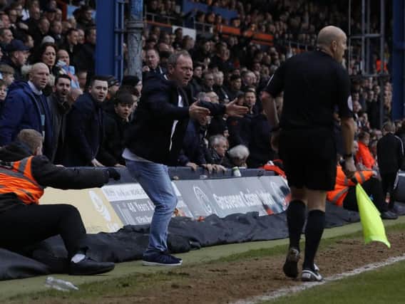 A Luton Town fan confronts the linesman during Town's 2-1 defeat to Accrington