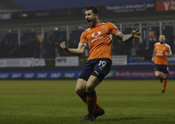 James Collins wheels away after making it 2-0 to Luton