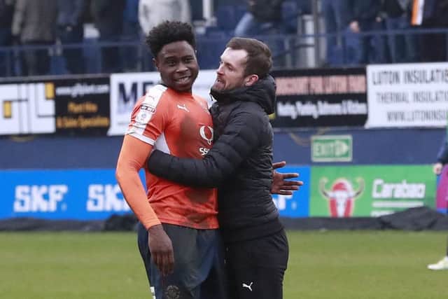 Hatters boss Nathan Jones with a hug for his midfielder