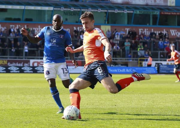 Hatters midfielder Olly Lee chips the ball forward against Carlisle