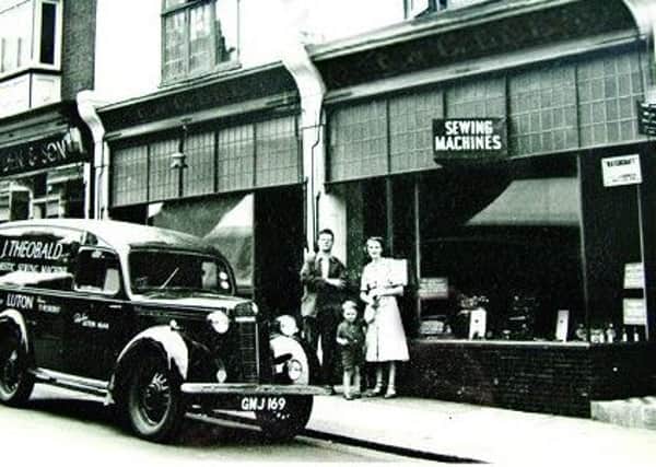Robert with his parents outside the shop on Wellington Street before it moved to the other side of the street