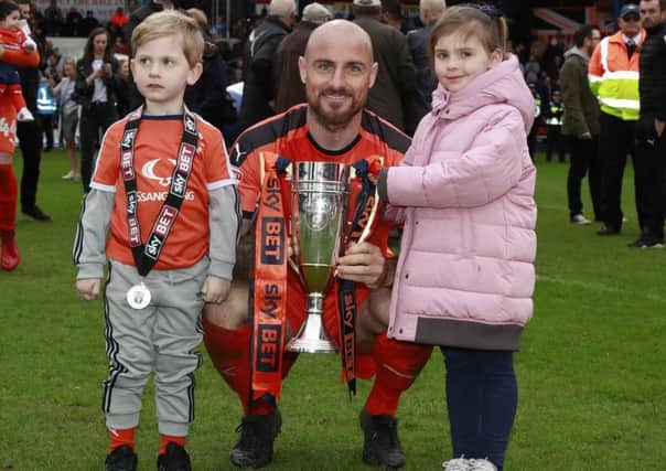 Alan McCormack celebrates with the League Two runners-up trophy