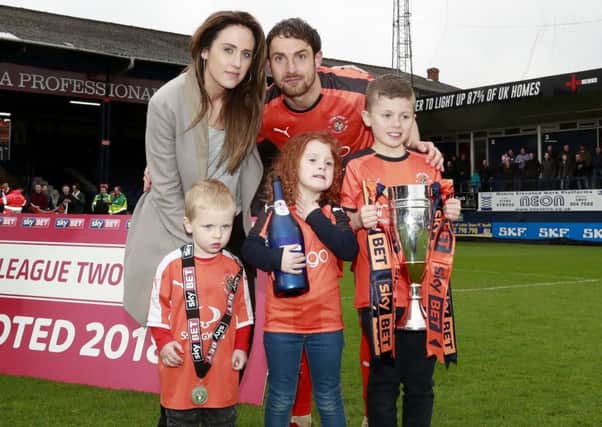 Danny Hylton celebrates promotion with his family at Kenilworth Road