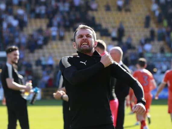 Hatters boss Nathan Jones celebrates promotion with the Luton fans