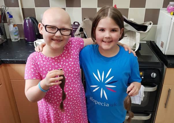 Jessie and Matilda after Jessie cut off 11 inches of hair for charity
