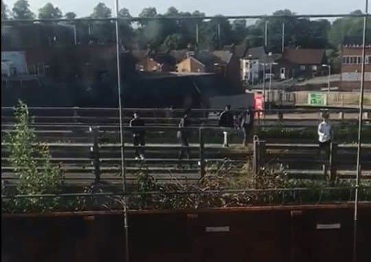 An image taken from a video showing boys throwing things at cars on Telford Way from a bridge