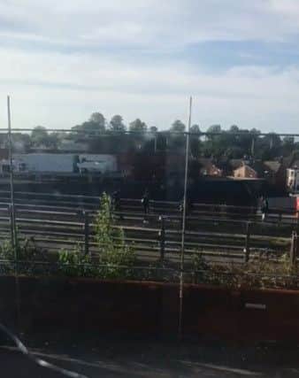 An image taken from a video showing boys throwing things at cars on Telford Way from a bridge