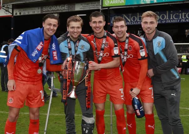 Luke Berry lifts the runners-up trophy with his Town team-mates