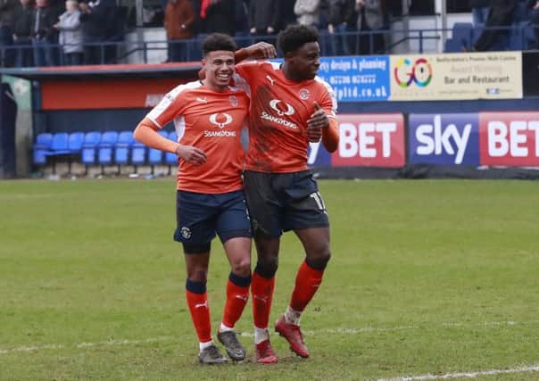 Hatters defender James Justin with Pelly-Ruddock Mpanzu