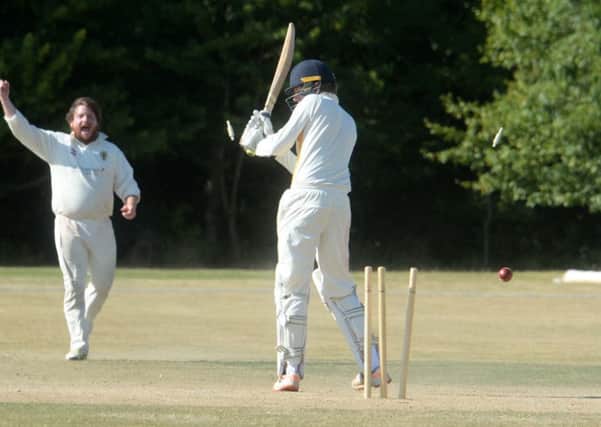 Dunstable bowler Matt Woodcock celebrates a wicket against Flitwick