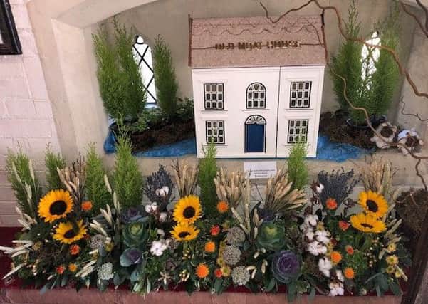 A model of The Old Moat House. The church thanks the business for its food and donations.