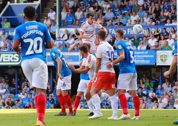 Dan Potts heads for goal against Portsmouth