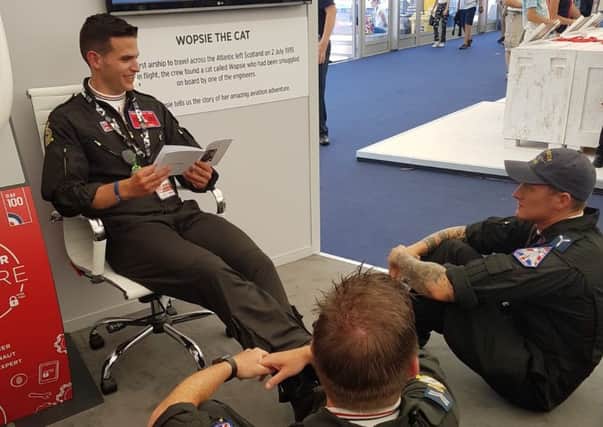 Photo of the RAF personnel from the Typhoon Force Team at RIAT reading the RAF100 inspired Wopsie the Cat story which aims to encourage children to become inventors of the future. Luton children are invited to participate in their STEM competition to design an aircraft of the future to take Wopsie on her next journey. Find out more here: http://www.uk.leonardocompany.com/people-careers/supporting-uk-armed-forces/raf100/wopsies-tale